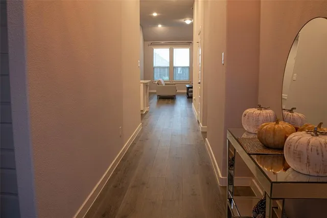 a hallway with couches and wooden floor
