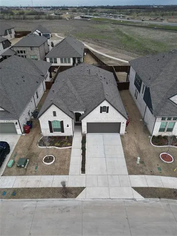 an aerial view of a house with outdoor space