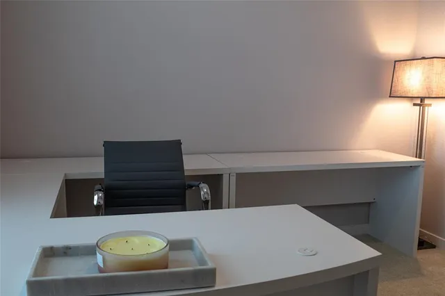 a living room with furniture and a lamp