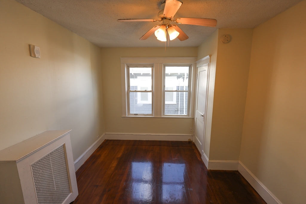 144 Blake Street, Unit 2 Boston, MA 02136 - Photo 12 of 28 wooden floor in an empty room with a window
