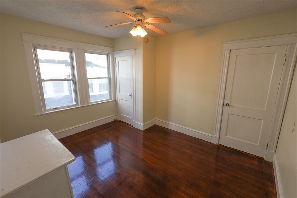 144 Blake Street, Unit 2 Boston, MA 02136 - Photo 13 of 28 wooden floor in an empty room with a window