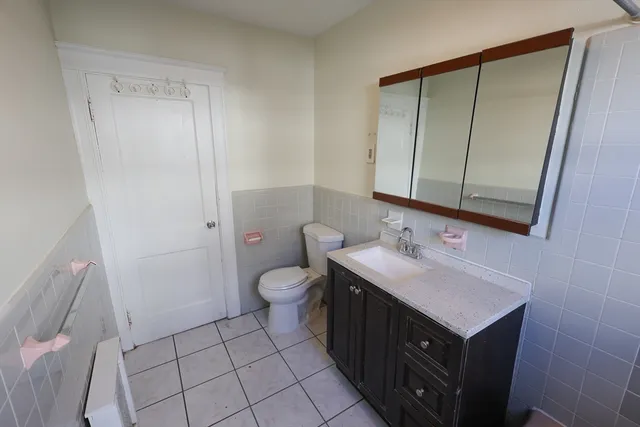 a bathroom with a sink a toilet and mirror