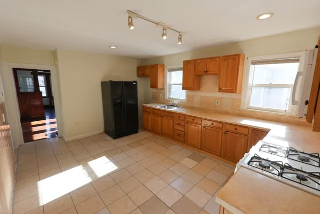 a kitchen with stainless steel appliances granite countertop a refrigerator and a sink