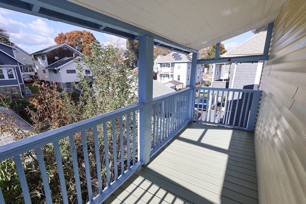 144 Blake Street, Unit 2 Boston, MA 02136 - Photo 28 of 28 a balcony with wooden floor