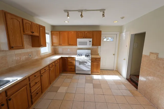 a kitchen with stainless steel appliances granite countertop a sink and cabinets