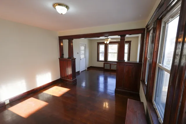wooden floor in an empty room with a window