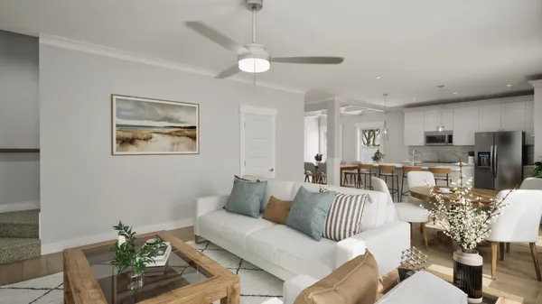 a living room with furniture and view of kitchen