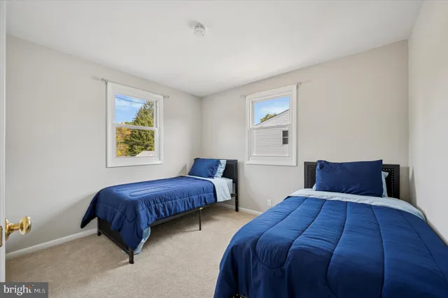 a bedroom with a bed and painting on the wall