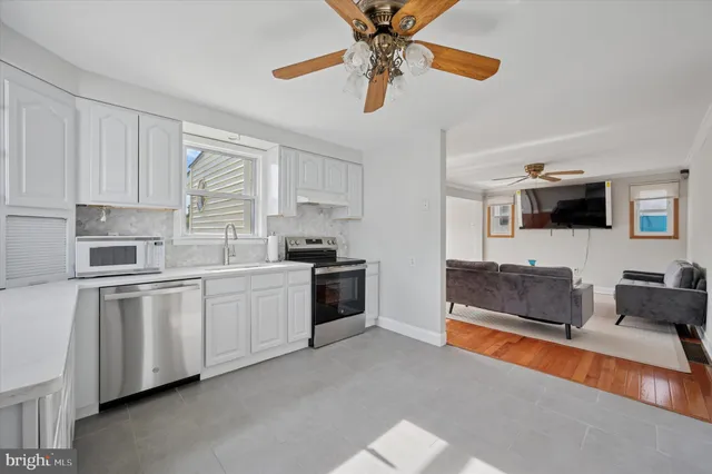 a kitchen with stainless steel appliances kitchen island granite countertop a sink and cabinets
