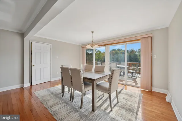 a dining room with furniture wooden floor and a rug