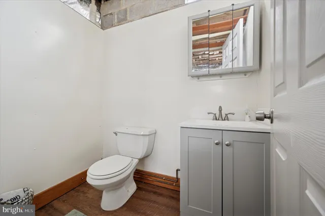 a bathroom with a sink a toilet and mirror