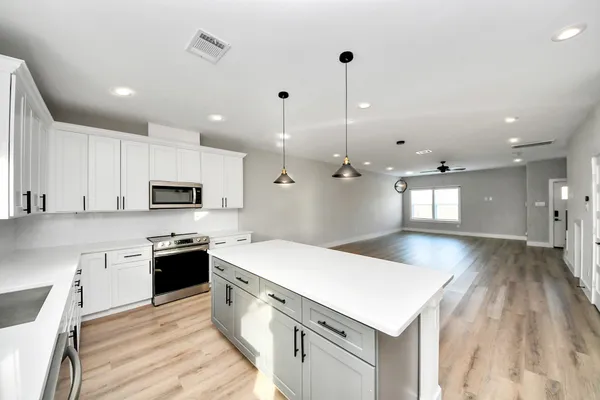 a large kitchen with stainless steel appliances kitchen island a large island in the center