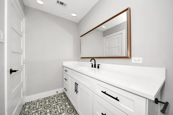 a bathroom with a sink and a mirror