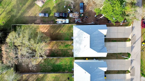 an aerial view of residential houses with outdoor space and swimming pool
