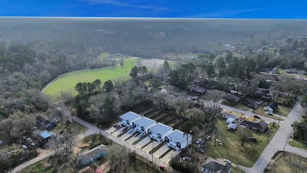 an aerial view of a house with a yard