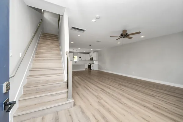 a view of entryway and hall with wooden floor