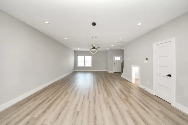 a view of an empty room and glass door