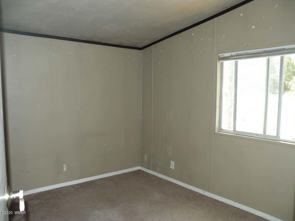 2055 Chevelon Road Overgaard, AZ 85933 - Photo 18 of 23 a view of an empty room with a window