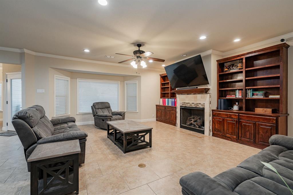 2687 McClendon Road Weatherford, TX 76088 - Photo 11 of 40 a living room with furniture a fireplace a flat screen tv and couches