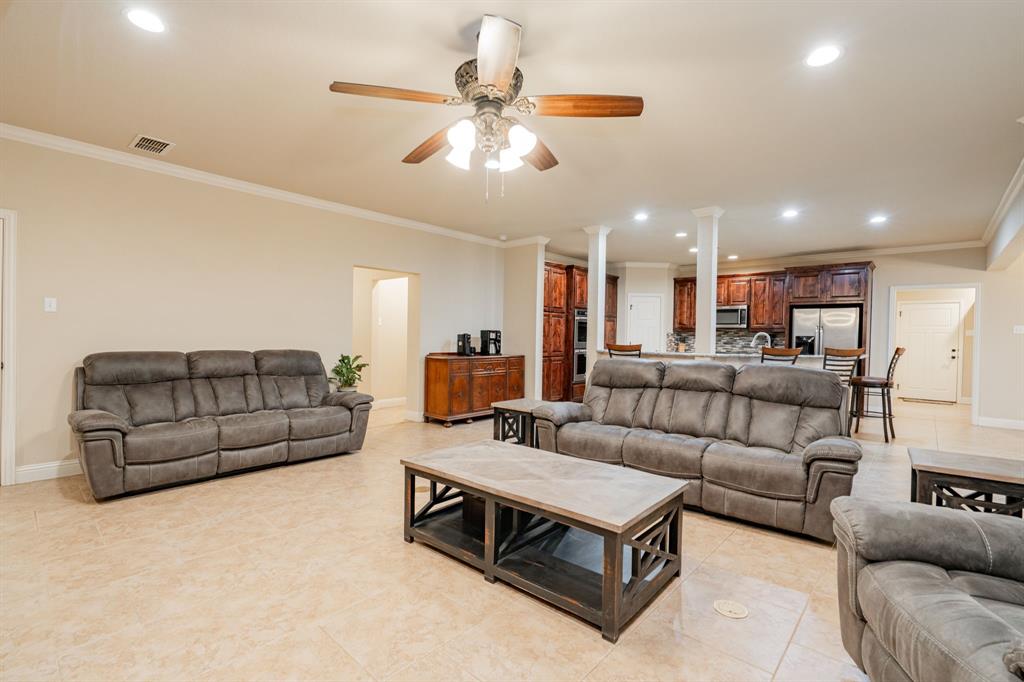 2687 McClendon Road Weatherford, TX 76088 - Photo 14 of 40 a living room with furniture kitchen view and a chandelier