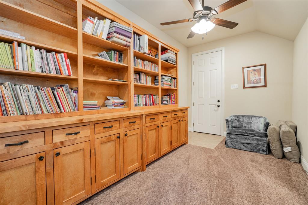 2687 McClendon Road Weatherford, TX 76088 - Photo 26 of 40 a spacious bedroom with a bed and a book shelf
