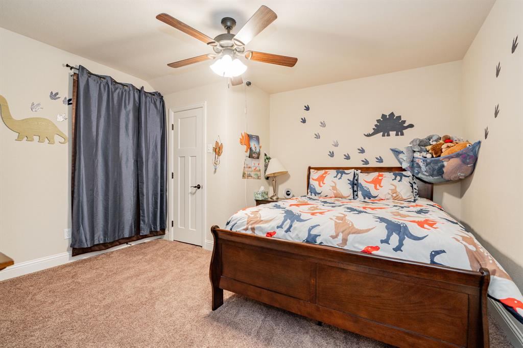 2687 McClendon Road Weatherford, TX 76088 - Photo 29 of 40 a bedroom with bed and wooden floor