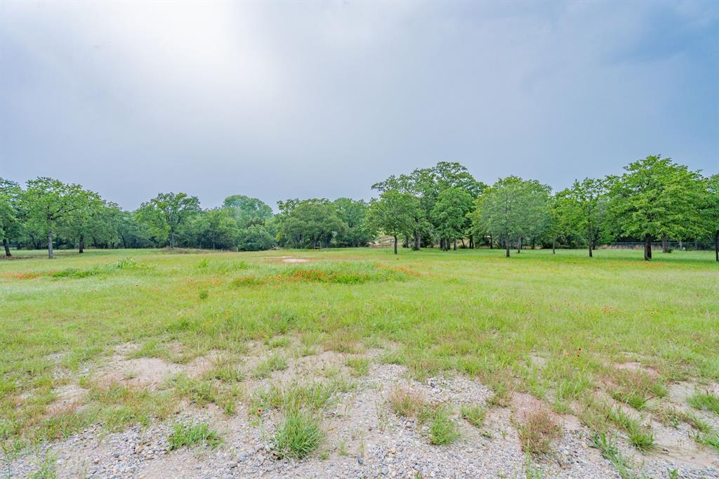 2687 McClendon Road Weatherford, TX 76088 - Photo 39 of 40 a view of a garden with a building in the background
