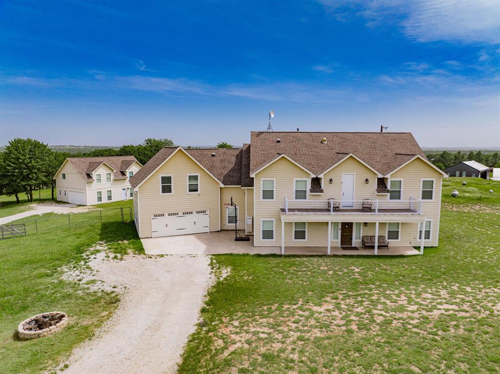 2687 McClendon Road Weatherford, TX 76088 - Photo 3 of 40 a aerial view of a house next to a yard with big trees