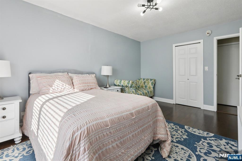 150 Overlook Avenue, Unit 7F Hackensack, NJ 07601 - Photo 11 of 24 a bedroom with a bed and wooden floor