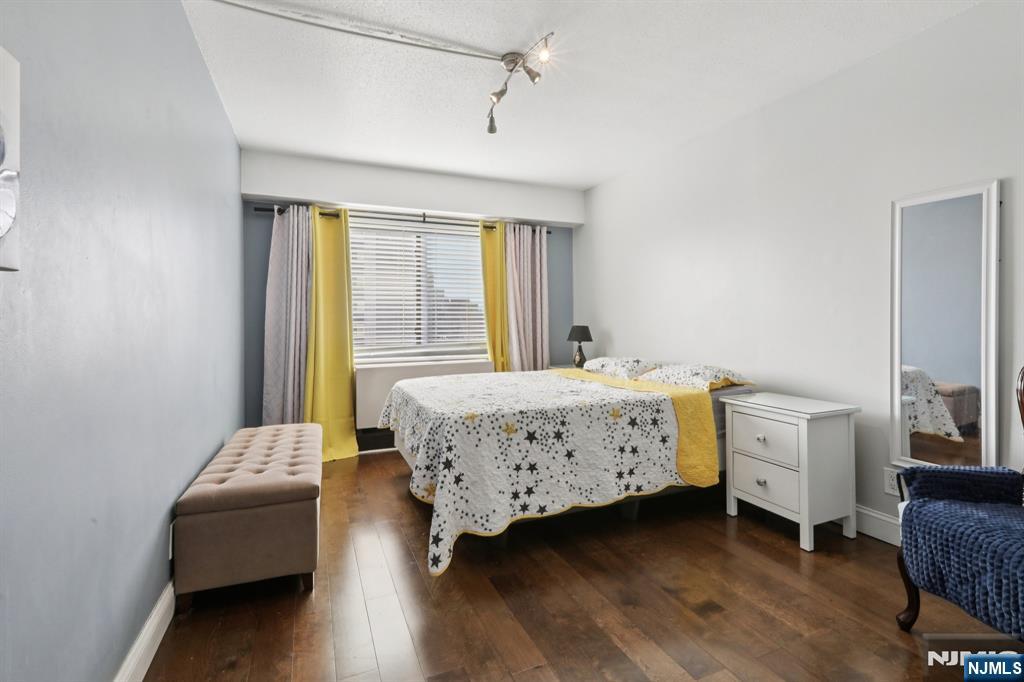 150 Overlook Avenue, Unit 7F Hackensack, NJ 07601 - Photo 12 of 24 a bedroom with a bed and a chair