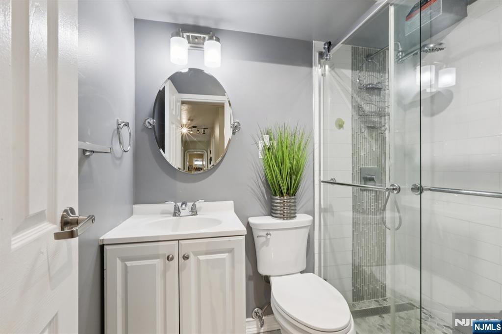 150 Overlook Avenue, Unit 7F Hackensack, NJ 07601 - Photo 13 of 24 a bathroom with a toilet sink and shower