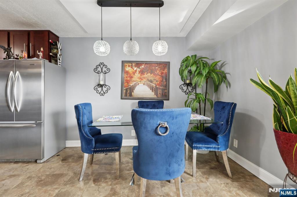 150 Overlook Avenue, Unit 7F Hackensack, NJ 07601 - Photo 6 of 24 a view of a dining room with furniture and a chandelier