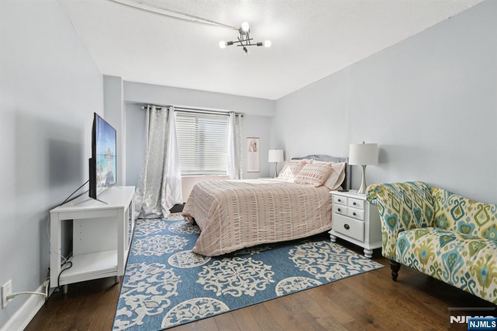 150 Overlook Avenue, Unit 7F Hackensack, NJ 07601 - Photo 10 of 24 a bedroom with furniture and a window