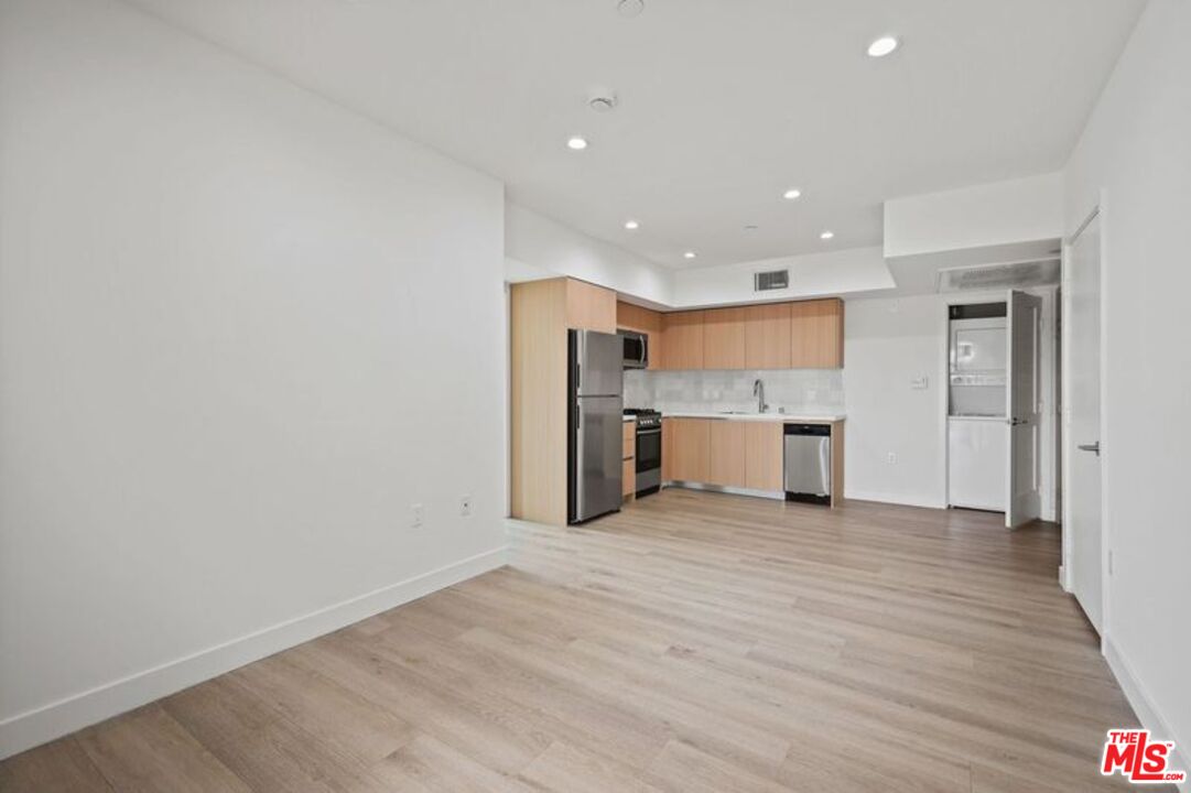 1600 Venice Blvd., Unit 102 Venice, CA 90291 - Photo 11 of 15 a view of a kitchen with a sink and wooden cabinets