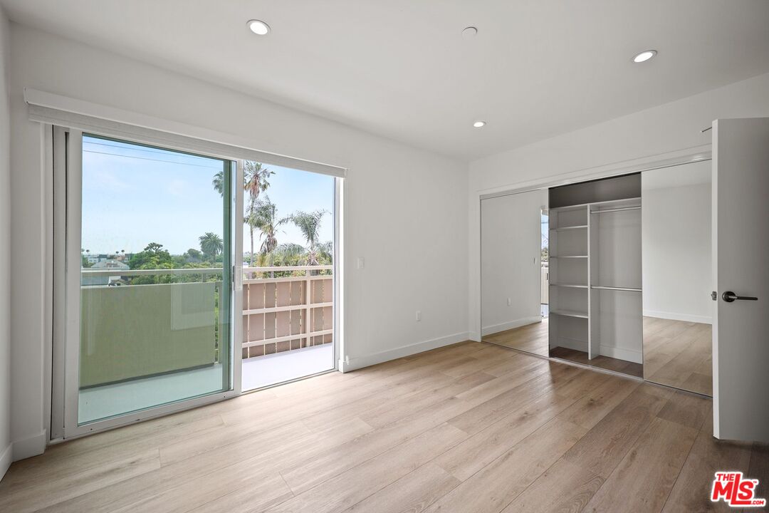 1600 Venice Blvd., Unit 102 Venice, CA 90291 - Photo 14 of 15 an empty room with wooden floor and sliding door