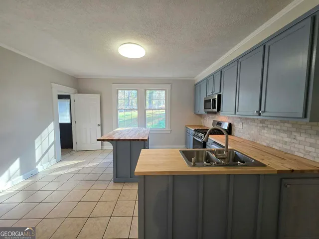 a kitchen with a sink cabinets and window