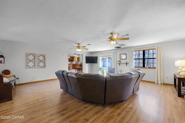 a living room with furniture and wooden floor