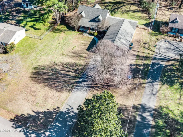 a view of a patio with chairs and potted plants
