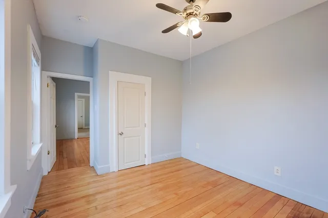 a view of an empty room and wooden floor