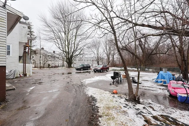 a view of a white house with a snow on the road
