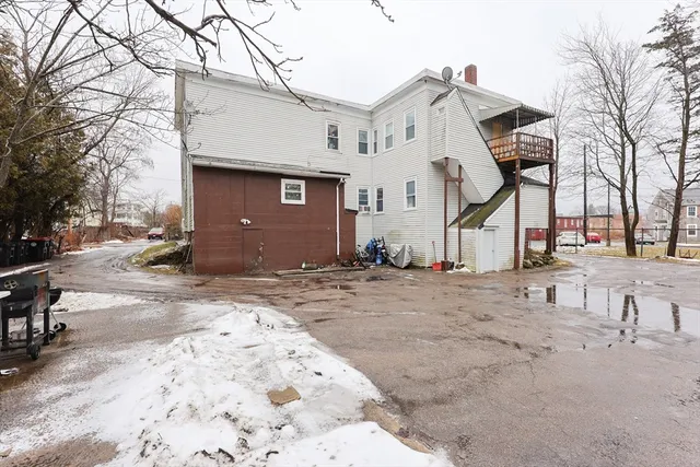a view of a house with a snow on the road