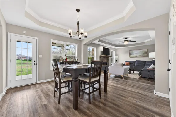 a view of a dining room with furniture wooden floor and a chandelier