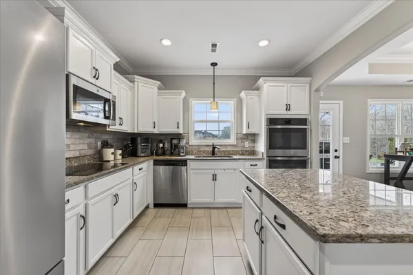a kitchen with granite countertop a sink and a window