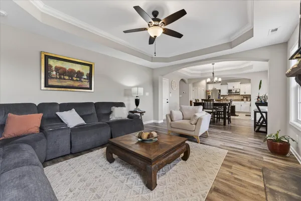 a living room with furniture a flat screen tv and a fireplace