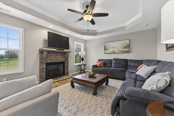 a living room with a fireplace and a floor to ceiling window