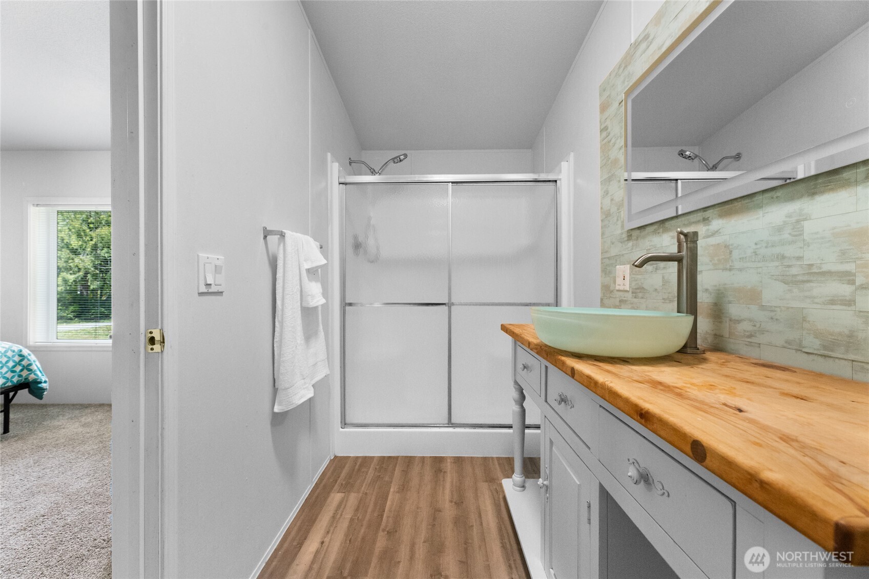 16037 Vail Loop Road Southeast Rainier, WA 98576 - Photo 15 of 32 a bathroom with a granite countertop sink a mirror and shower