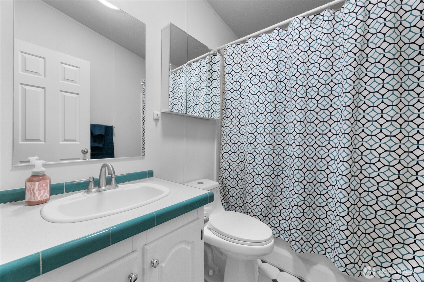 16037 Vail Loop Road Southeast Rainier, WA 98576 - Photo 18 of 32 a bathroom with a granite countertop toilet and sink