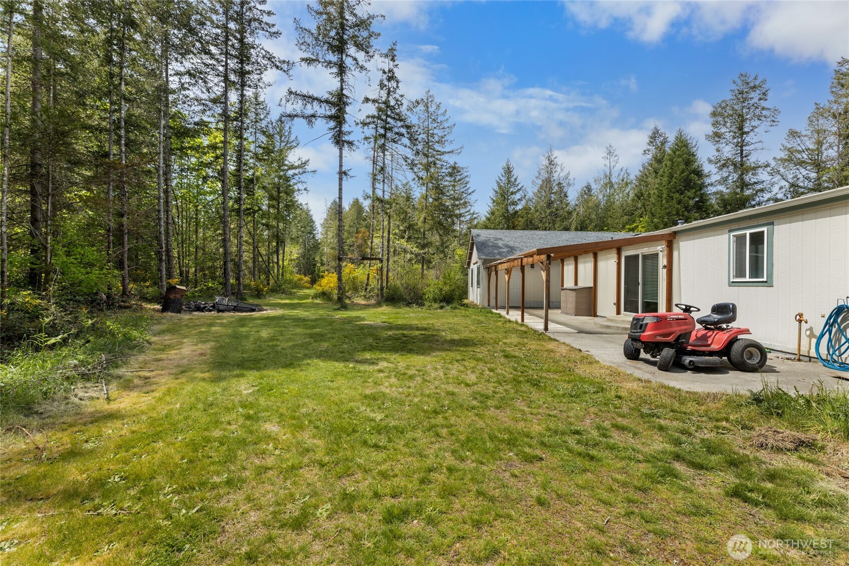 16037 Vail Loop Road Southeast Rainier, WA 98576 - Photo 22 of 32 a view of a house with backyard and trees