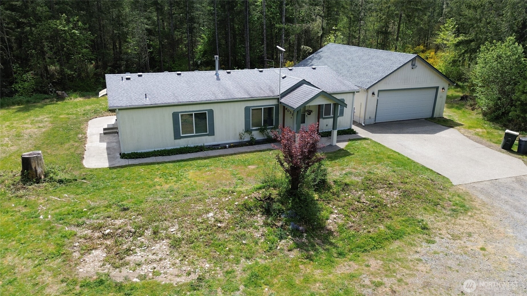 16037 Vail Loop Road Southeast Rainier, WA 98576 - Photo 32 of 32 a front view of house with yard and trees in the background