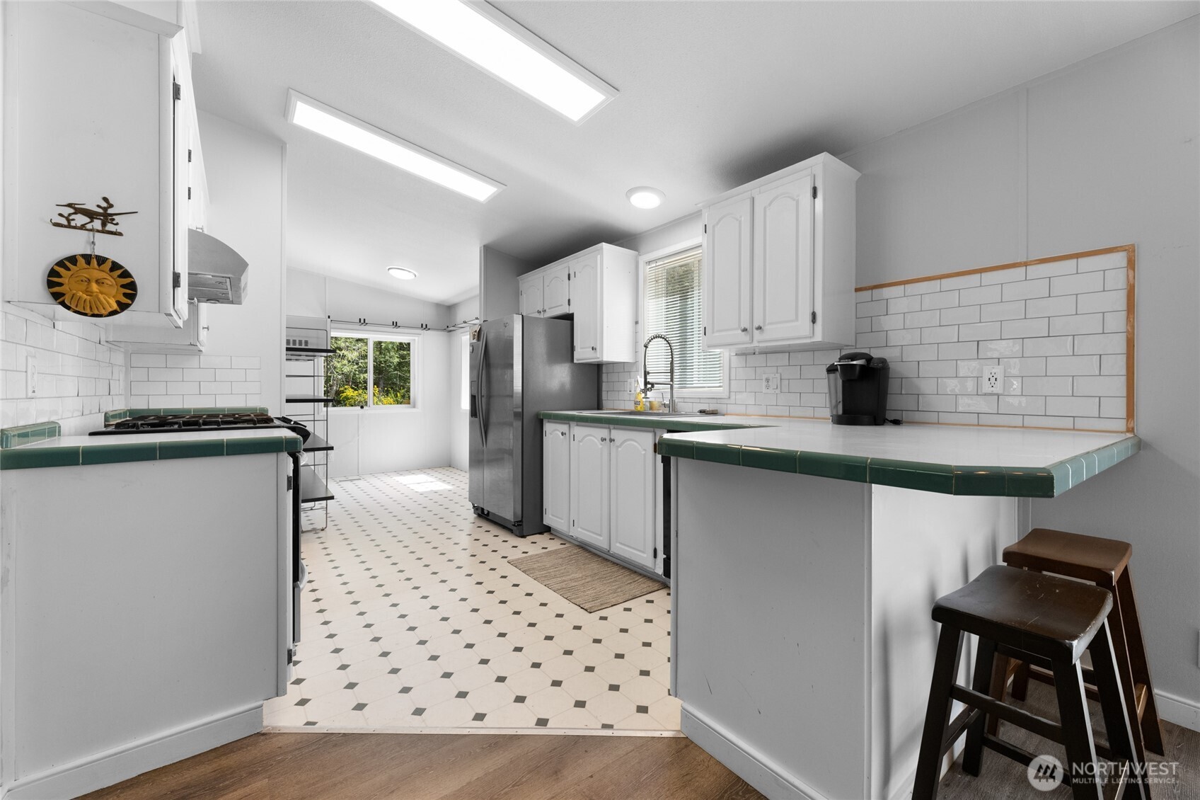 16037 Vail Loop Road Southeast Rainier, WA 98576 - Photo 5 of 32 a kitchen with stainless steel appliances kitchen island granite countertop a sink and wooden cabinets